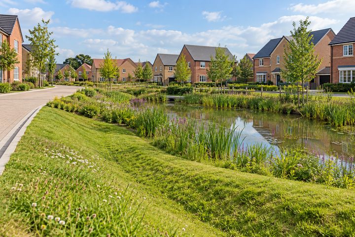 A housing development with a grassed swale, an attenuation pond and permeable paving